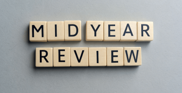 Image of dice spelling the topic mid year review