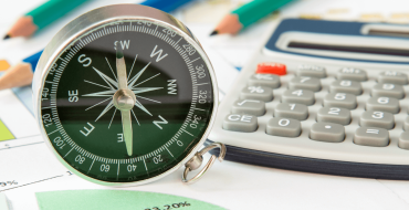 Image Navigating Disruption showing compass, calculator, papers