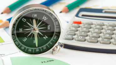 Image Navigating Disruption showing compass, calculator, papers